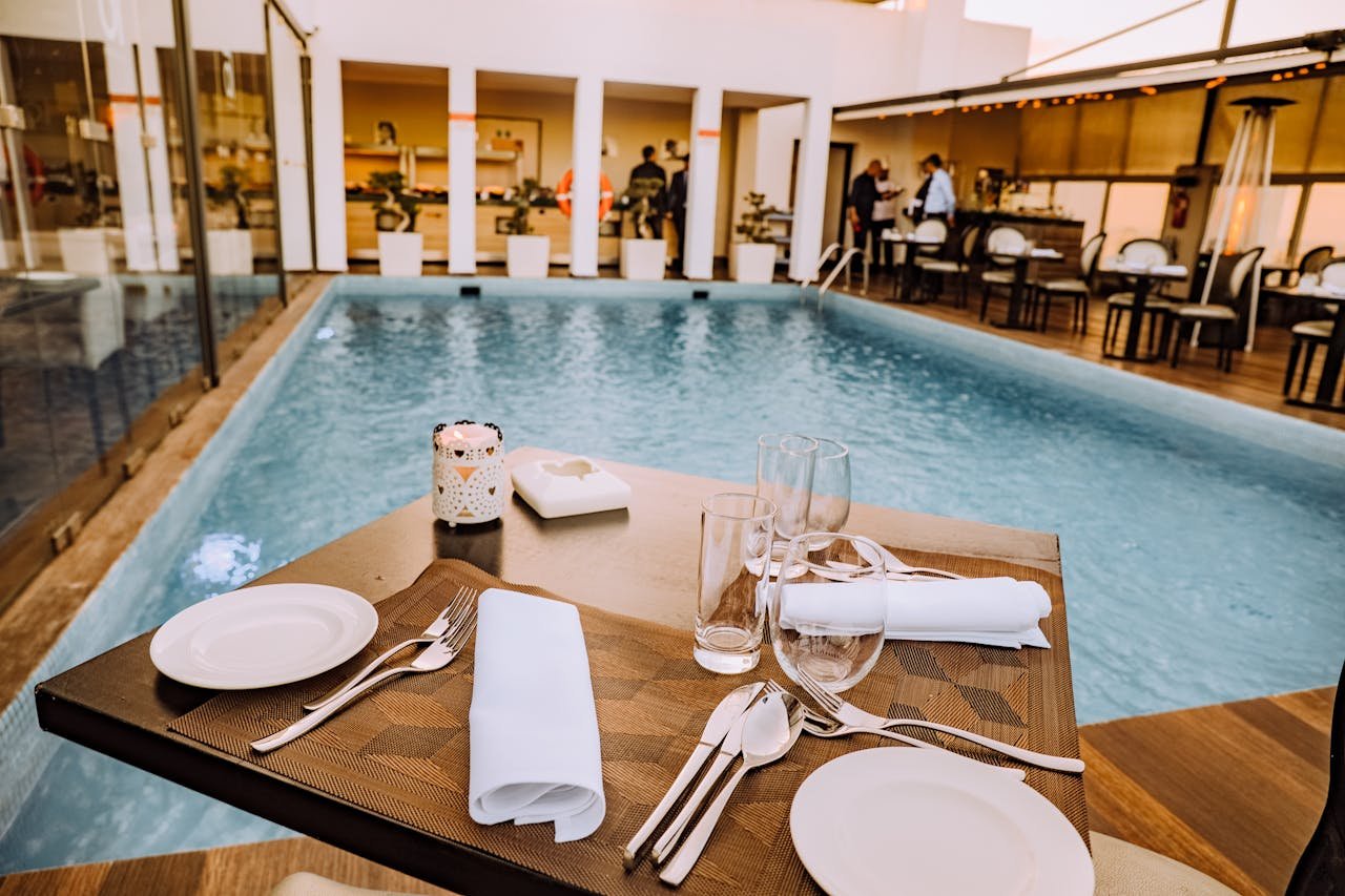 Relax by the poolside with this elegant dining setup at a luxurious resort.